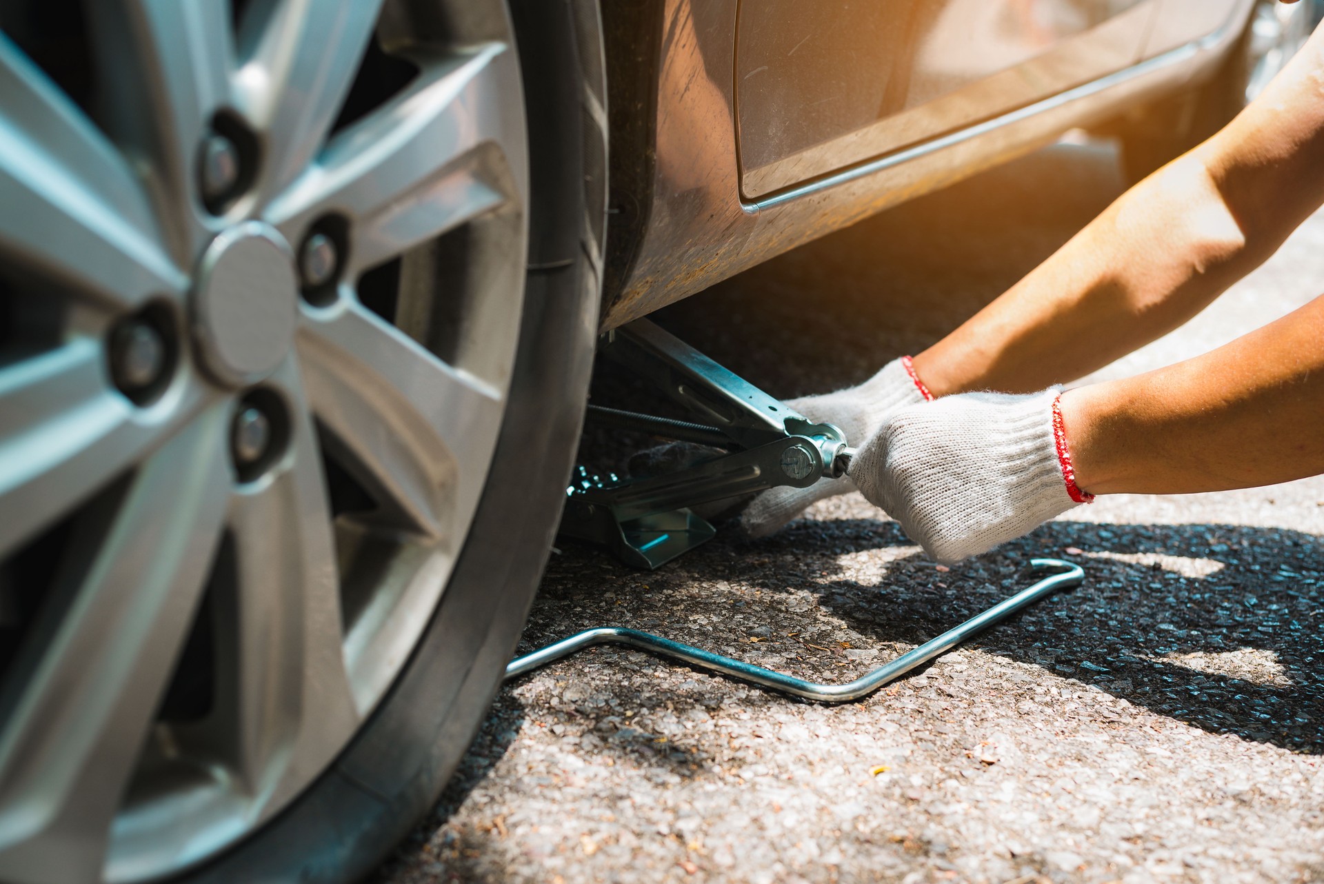 Changing the tire car on a road,Man changing wheel after a car breakdown. Transportation, traveling concept.